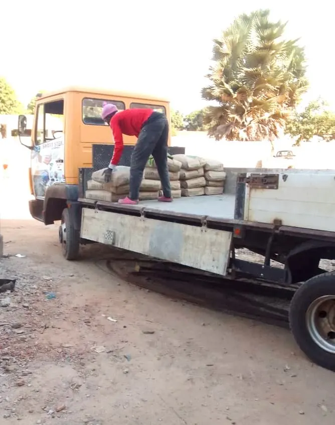 Cement bags being loaded onto a Smart Steel Enterprise flatbed truck